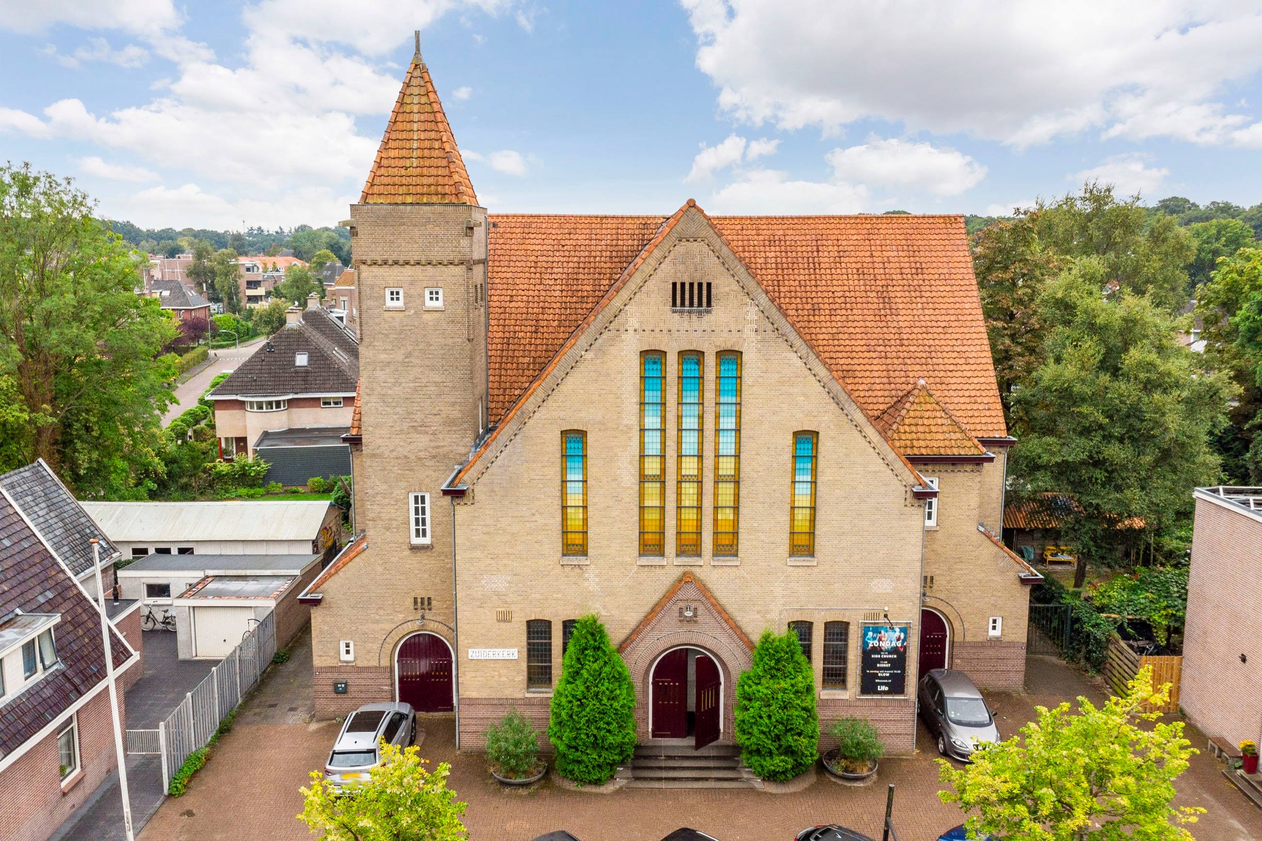 The Zuiderkerk in Assen from above, showing the tower and the tiled roof against the town beyond.