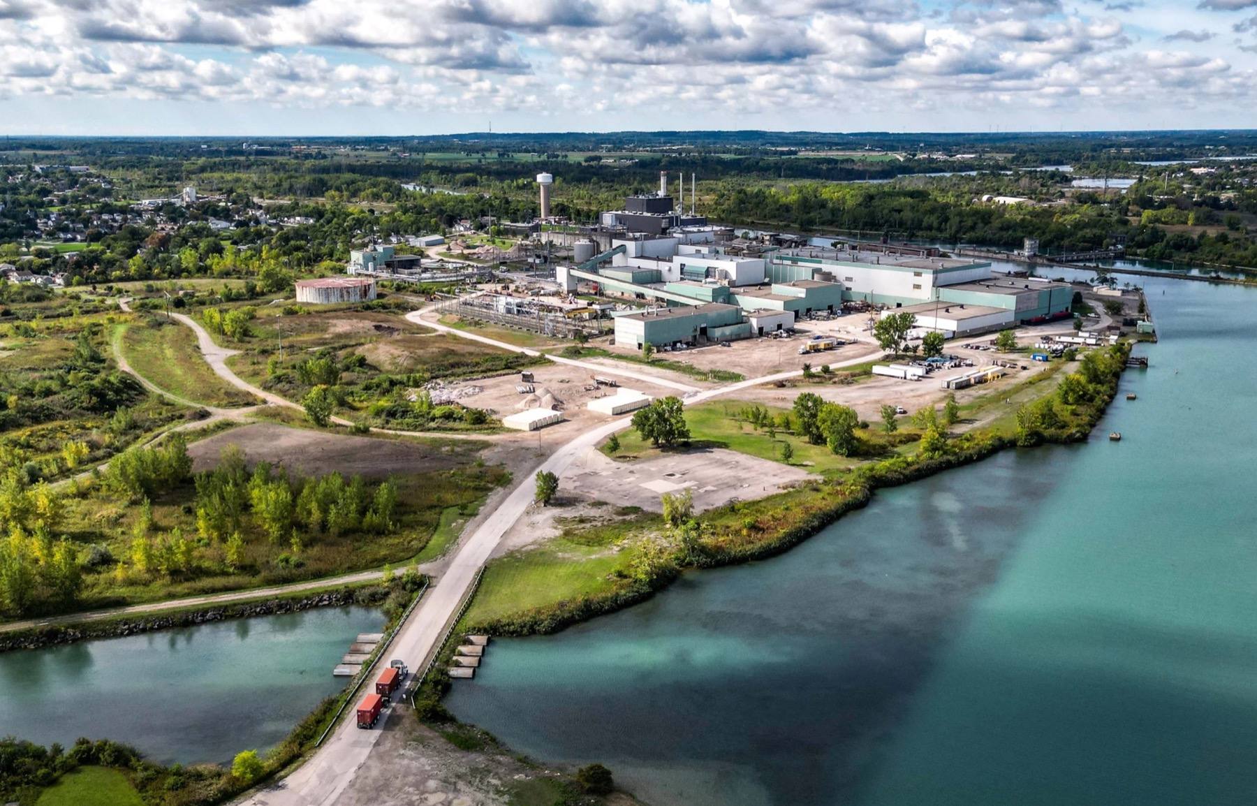 An industrial zone under development in Canada, seen from the air beside a river.